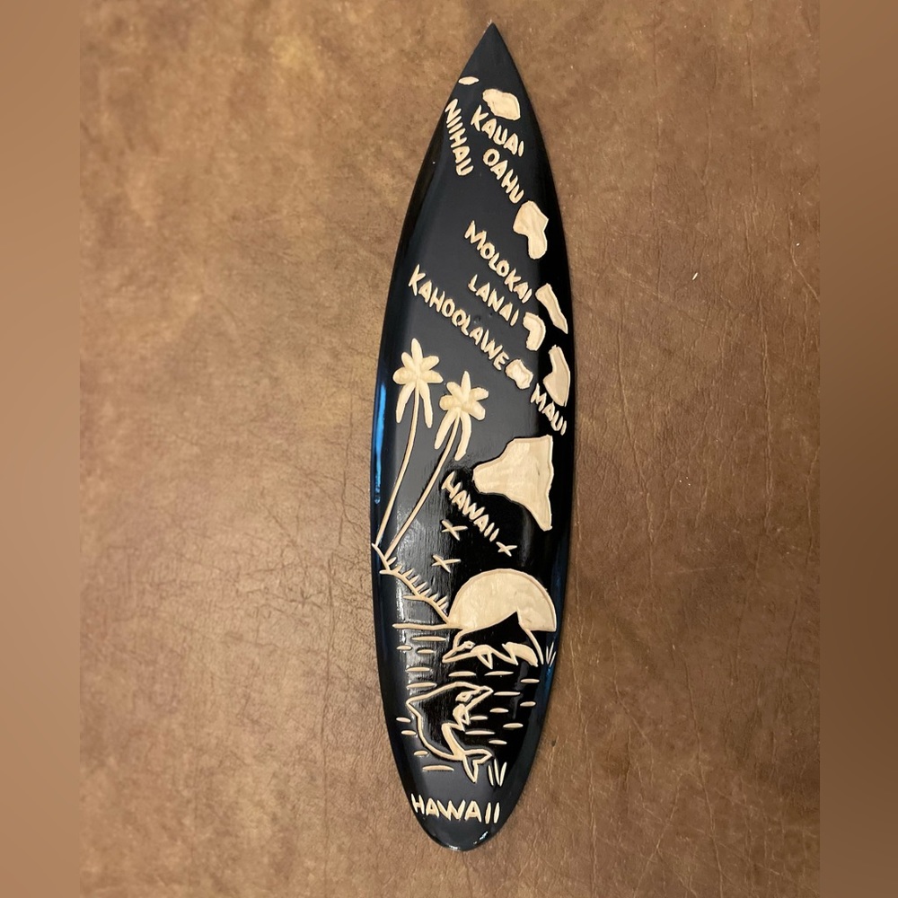 Wooden surfboard with Hawaii islands carved